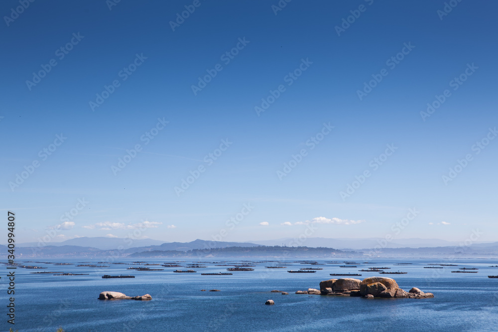 Obraz premium Stunning views of the oyster farms of Galicia Spain on a calm sunny day