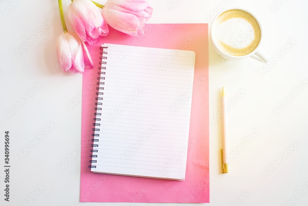 Empty notebook spring pink tulips flowers, cup of coffee. Mockup notepad on pink background. Still life. Spring romantic mood. Colorful light. Feminine desctop. Top view. Copy space Empty notebook spring pink tulips flowers, cup of coffee. Mockup notepad on pink background. Still life. Spring romantic mood. Colorful light. Feminine desctop. Top view. Copy space