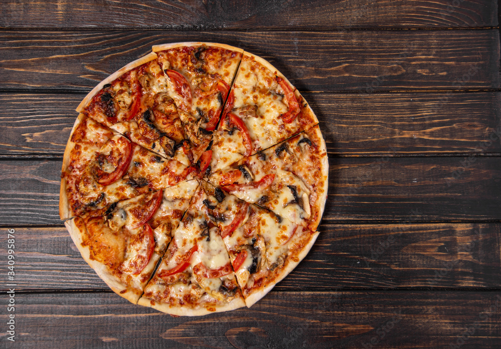 Pizza with mushrooms and chicken on a wooden table. Pizza with mushrooms and chicken on a wooden table.