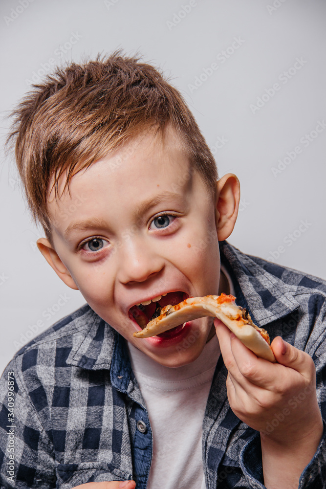 The guy with great pleasure eats a piece of pizza The guy with great pleasure eats a piece of pizza