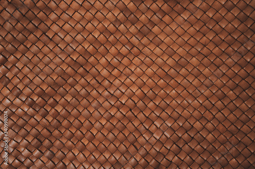Vintage brown braided leather texture. Leather woven together. Abstract clothing background. Natural material. Horizontal backdrop.