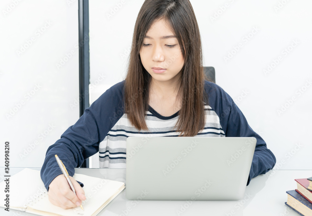 Young female student sitting in living room and learning online Young female student sitting in living room and learning online