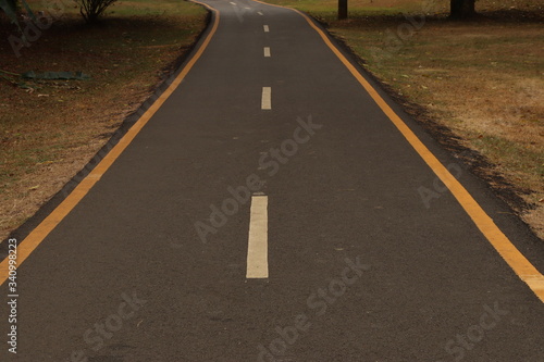 asphalt road with yellow lines