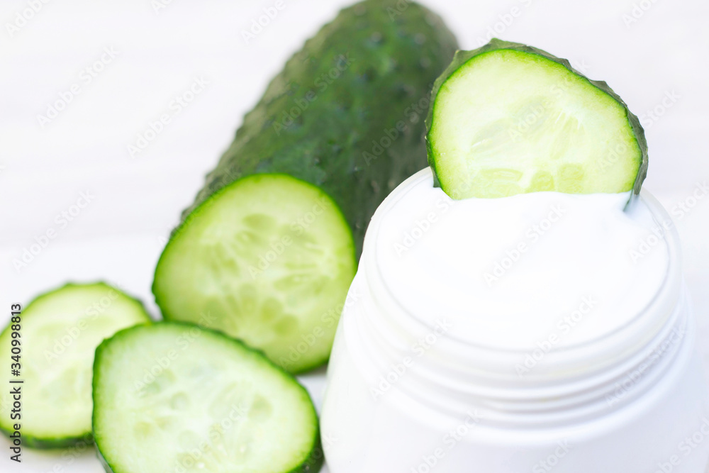 Cucumber cream. Natural cream with fresh cucumber. on a light background in the spa salon or at home. Cucumber cream. Natural cream with fresh cucumber. on a light background in the spa salon or at home.