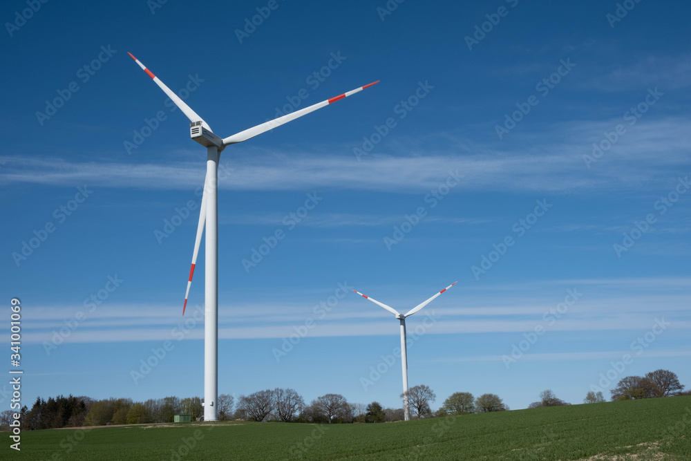two windmills, wind energy on a green field two windmills, wind energy on a green field