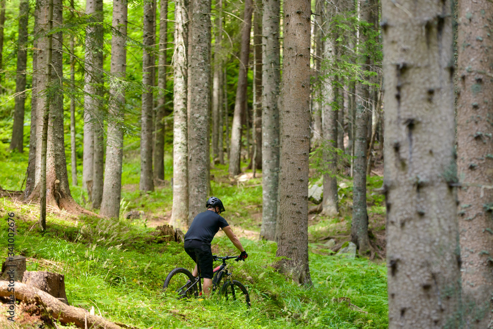 Male cyclist with electric mountainbike in the forest