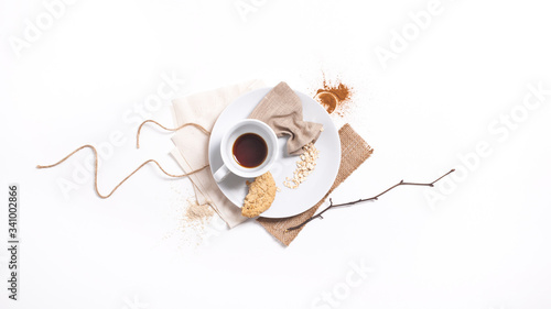 Top view of minimalist breakfast served with coffee, bran, spices, cookie, bright colors
