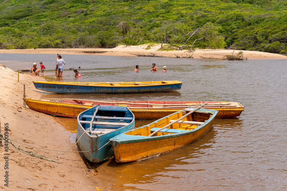 Guaju river, Sagi beach, Baia Formosa, near Natal and Pipa beach, Rio Grande do Norte, Brazil on April 19, 2015. Colorful boats and tourists Guaju river, Sagi beach, Baia Formosa, near Natal and Pipa beach, Rio Grande do Norte, Brazil on April 19, 2015. Colorful boats and tourists