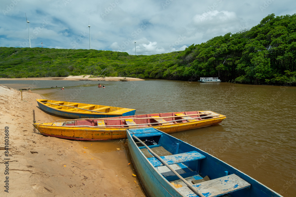 Guaju river, Sagi beach, Baia Formosa, near Natal and Pipa beach, Rio Grande do Norte, Brazil on April 19, 2015. Colorful boats and tourists