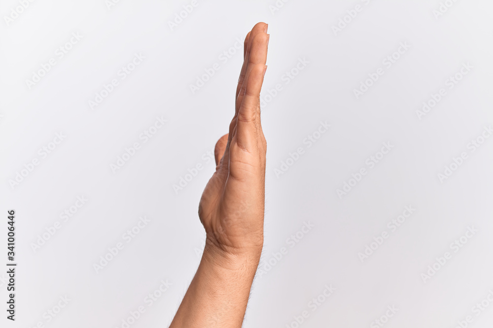 Hand of caucasian young man showing fingers over isolated white background showing side of stretched hand, pushing and doing stop gesture Hand of caucasian young man showing fingers over isolated white background showing side of stretched hand, pushing and doing stop gesture
