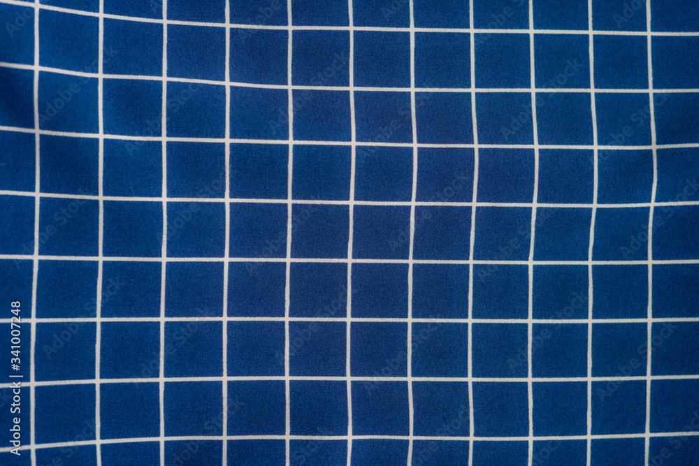 Backdrop made of dark blue squares on textile Backdrop made of dark blue squares on textile