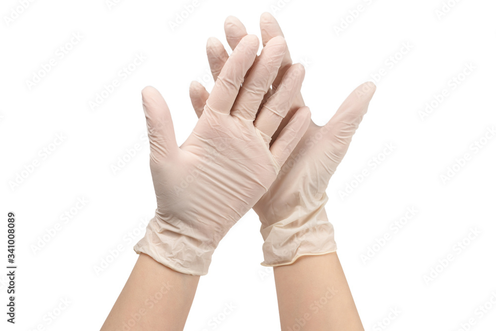 Woman puts on white rubber gloves. Woman puts on white rubber gloves.
