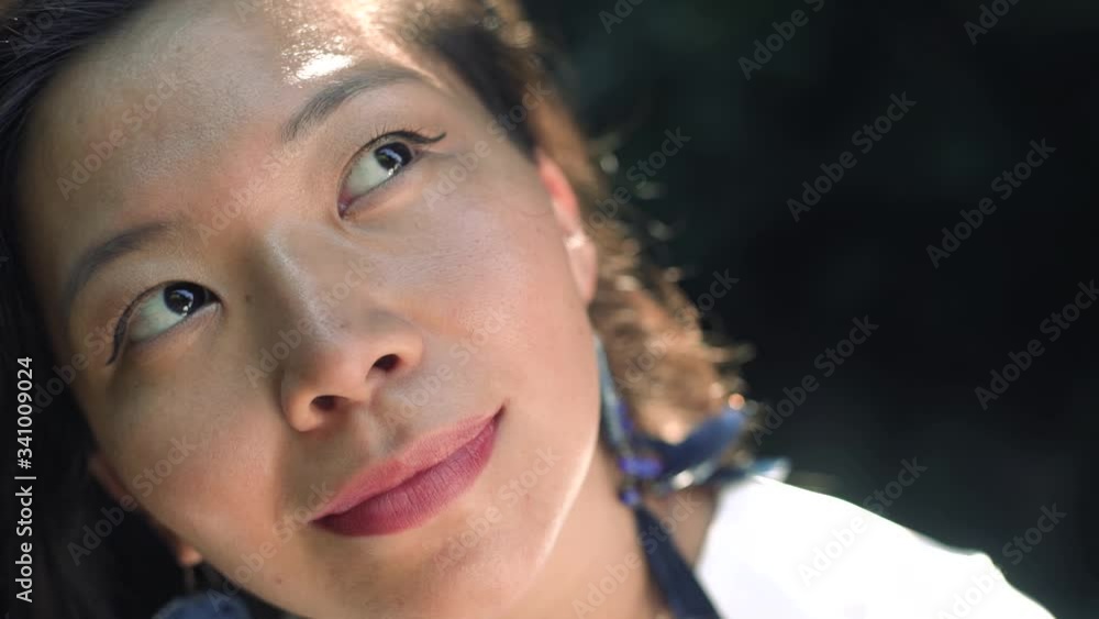 Close-up portrait of a happy young attractive asian girl looking up Close-up portrait of a happy young attractive asian girl looking up