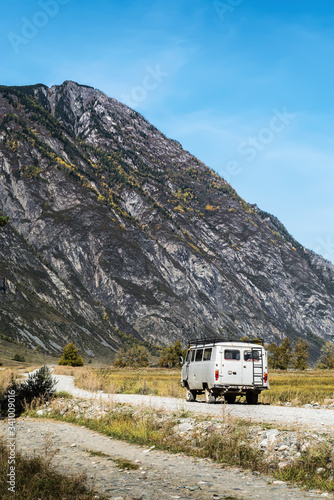 Chulyshman Valley, Altai Republic, Russia - September, 20, 2019: UAZ off-road minibus on a dirt road in a mountain valley