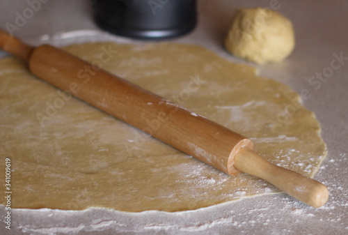 Roll out the dough on the table. Homemade cake.