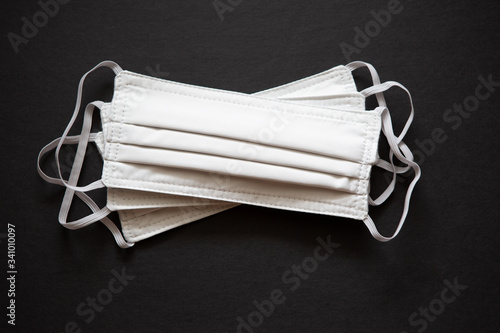 Trio of White Face Masks Isolated on Black Background