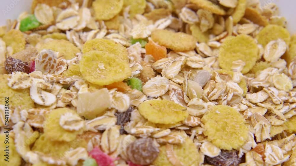 Dry muesli in a white bowl closeup Dry muesli in a white bowl closeup