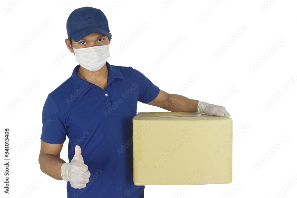 Delivery man wearing medical mask and gloves holding box in Hands and thumbs up on white background. Concept for delivery services courier during the Coronavirus (COVID-19) pandemic. Delivery man wearing medical mask and gloves holding box in Hands and thumbs up on white background. Concept for delivery services courier during the Coronavirus (COVID-19) pandemic.