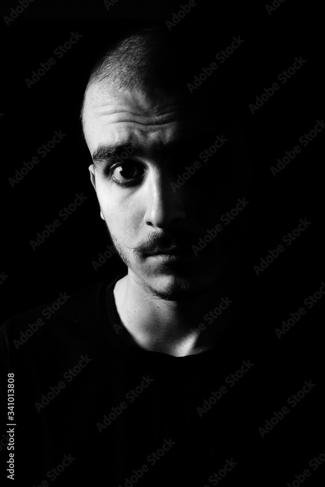 Portrait of a guy with moustache staring intensively into the camera Portrait of a guy with moustache staring intensively into the camera