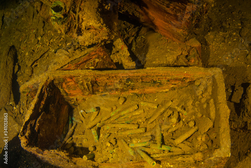 decaying wooden boxes filled with bullets shot in the cargo hold of a sunken ship. The vessel that held this cargo was a second world war Japanese ship that was sunk in Chuuk Lagoon during conflict photo