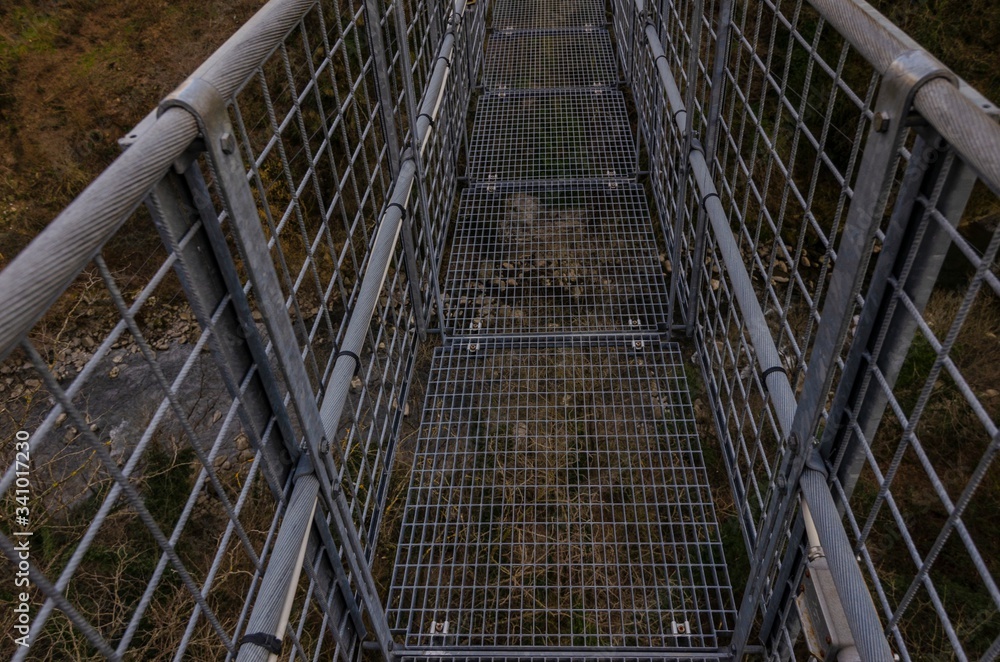 Suspension bridge walkway seen from above in the foreground Suspension bridge walkway seen from above in the foreground