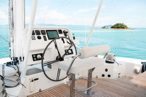 Steering wheel in control deck with monitors for an expensive luxury boat. Detail of the interior of a yacht. photo