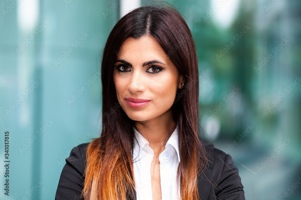Smiling businesswoman poirtrait in a confident expression outdoor Smiling businesswoman poirtrait in a confident expression outdoor