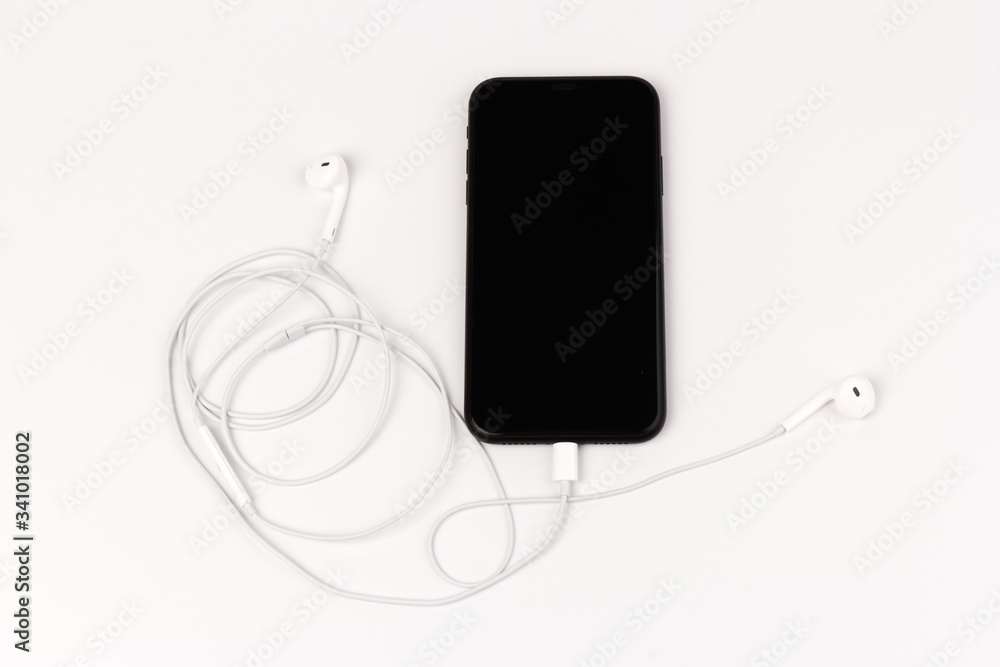 Creative flat lay photo of workspace desk with earphones and mobile phone Creative flat lay photo of workspace desk with earphones and mobile phone
