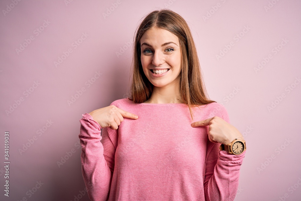 Young beautiful redhead woman wearing casual sweater over isolated blue background looking confident with smile on face, pointing oneself with fingers proud and happy. Young beautiful redhead woman wearing casual sweater over isolated blue background looking confident with smile on face, pointing oneself with fingers proud and happy.