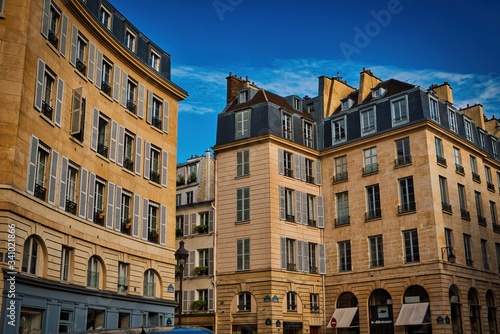 Paris buildings. Old Paris architecture, beautiful facade, typical french houses on sunny day. Famous travel destinations in Europe.