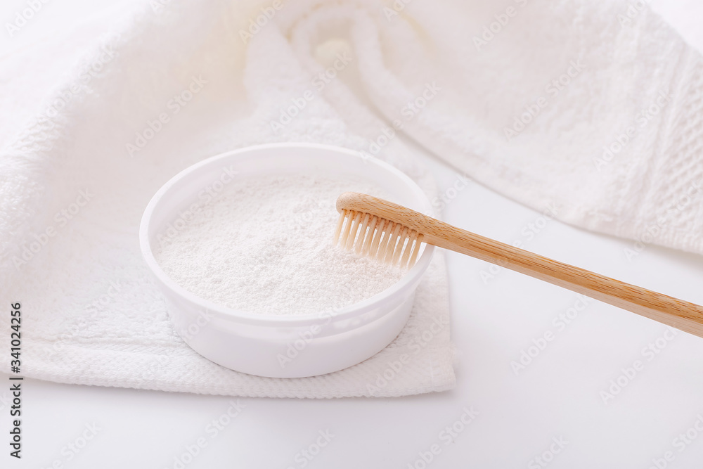 Wooden teeth brush and tooth-powder on white towel backgroud. Zero waste concept Wooden teeth brush and tooth-powder on white towel backgroud. Zero waste concept