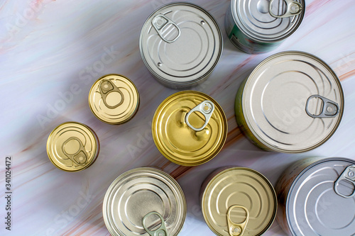 Overhead view row canned food in different sizes and colors. Stock non-perishable preserved food