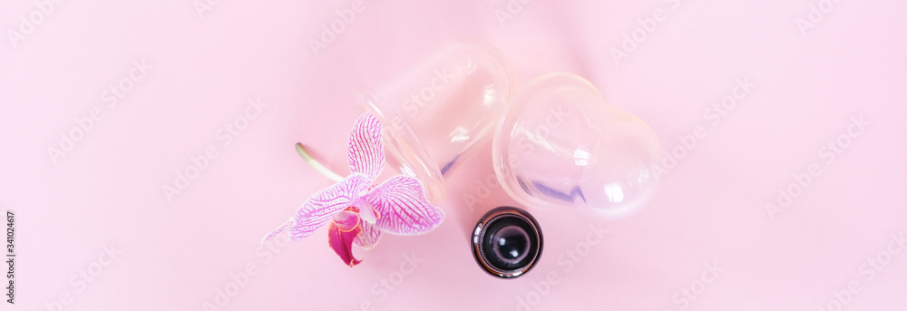 Vacuum cans for body on pink background. Rubber equipment for anti cellulite massage.