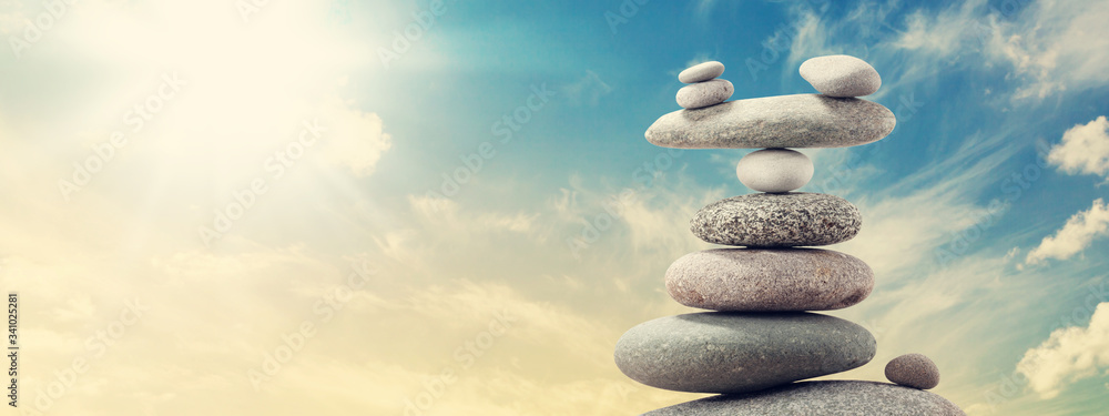 Pyramid of sea pebbles over a sunny sky Pyramid of sea pebbles over a sunny sky