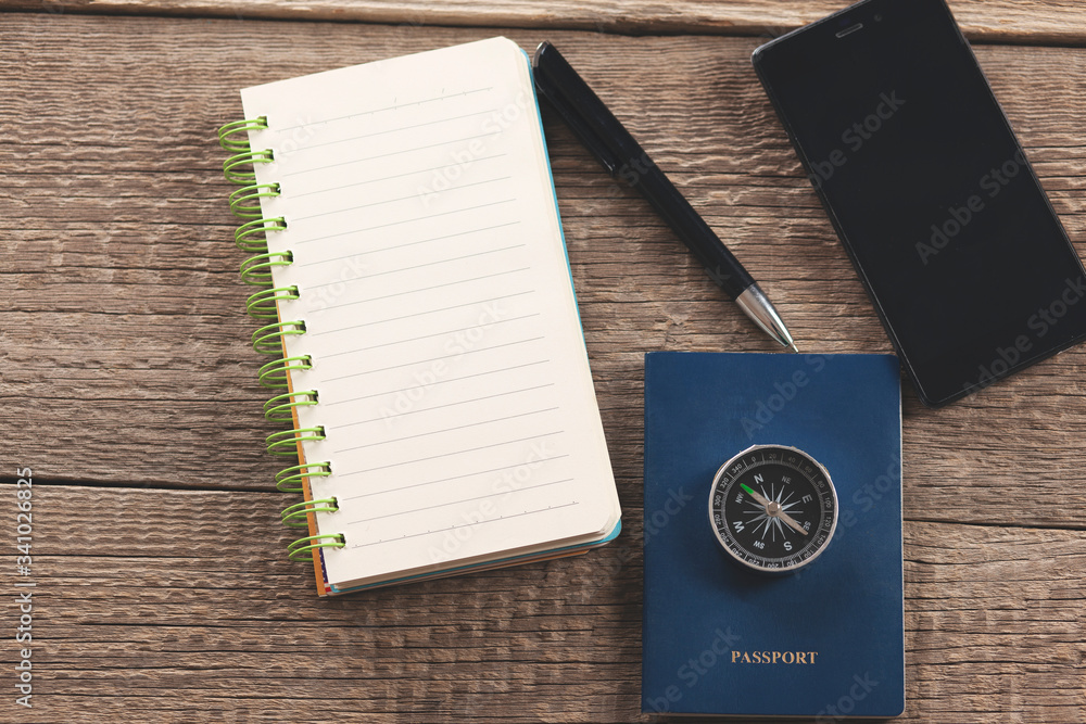 compass on passport on notepad