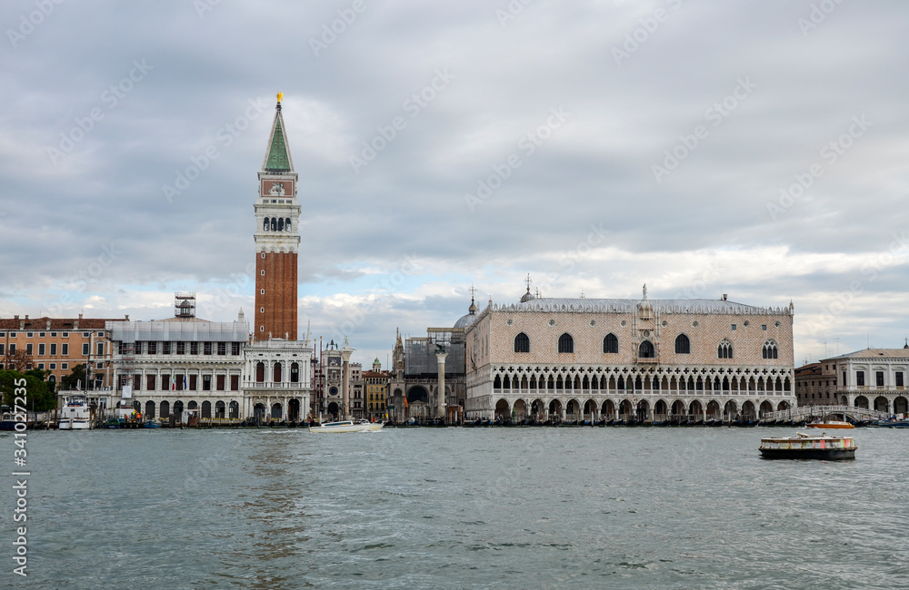 Beautiful view of Venice with Campanile tower of Saint Mark's Cathedral, Basilica on San Marco square and old Doge's palace. Famous romantic panorama of seafront city on water.