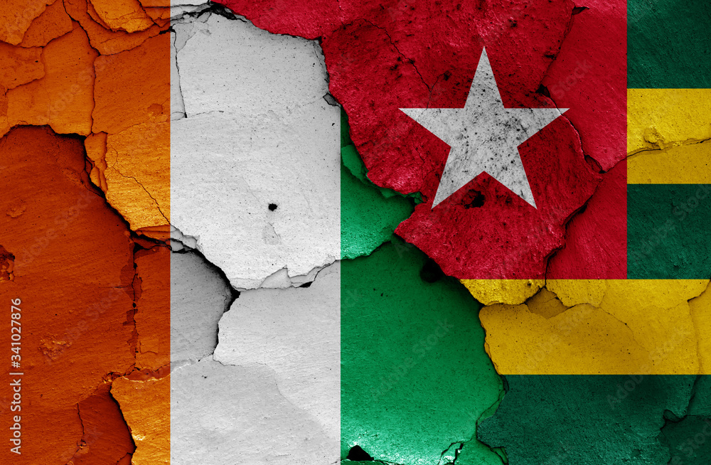 flags of Ivory Coast and Togo painted on cracked wall