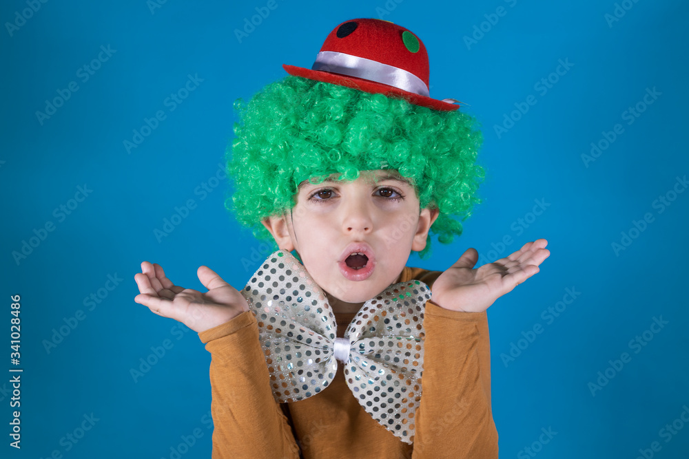 Little kid with clown costume isolated in blue