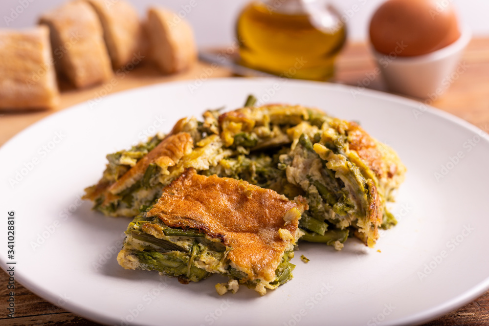 Slices of omelette with asparagus. Nutritious and quick lunch, based on proteins, good fats and vitamins. Slices of omelette with asparagus. Nutritious and quick lunch, based on proteins, good fats and vitamins.