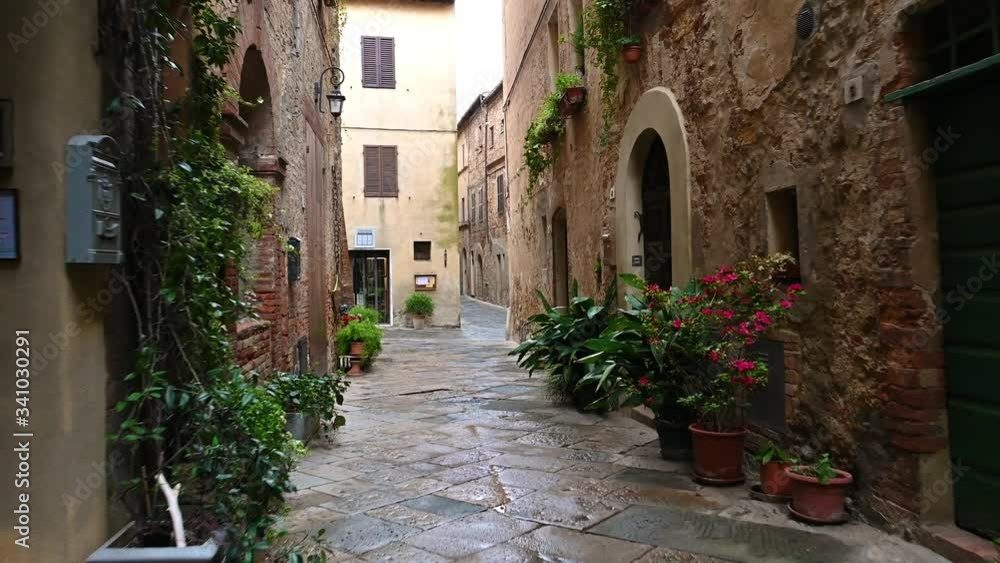 Smooth camera steady slide shot around old Tuscany village Pienza narrow empty streets, with old stone walls, shelled facades with flowers, early in the morning Smooth camera steady slide shot around old Tuscany village Pienza narrow empty streets, with old stone walls, shelled facades with flowers, early in the morning