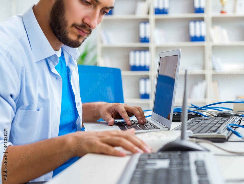 IT technician looking at IT equipment