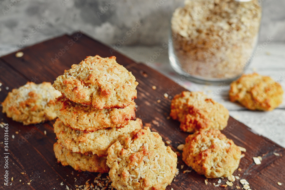 Oatmeal cookies on a wooden background. Close-up. Free space for text. Healthy homemade cookies. Sweet pastries. A stack of oatmeal cookies with coconut Oatmeal cookies on a wooden background. Close-up. Free space for text. Healthy homemade cookies. Sweet pastries. A stack of oatmeal cookies with coconut