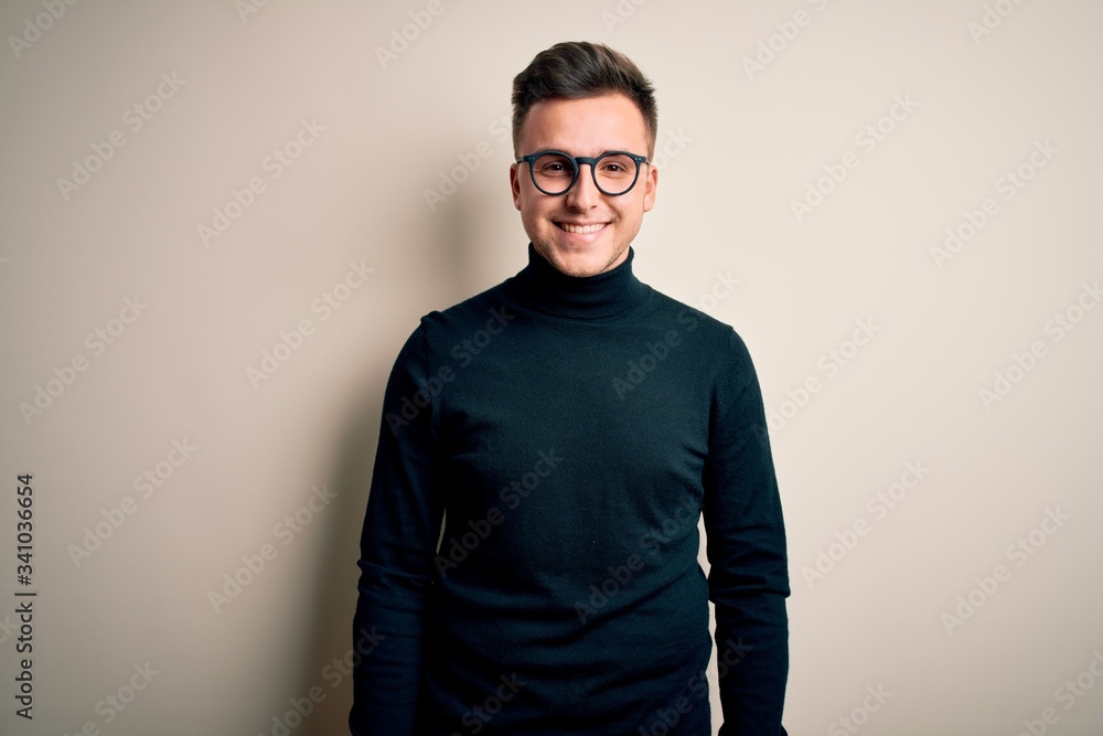 Young handsome caucasian man wearing glasses and casual sweater over isolated background with a happy and cool smile on face. Lucky person. Young handsome caucasian man wearing glasses and casual sweater over isolated background with a happy and cool smile on face. Lucky person.