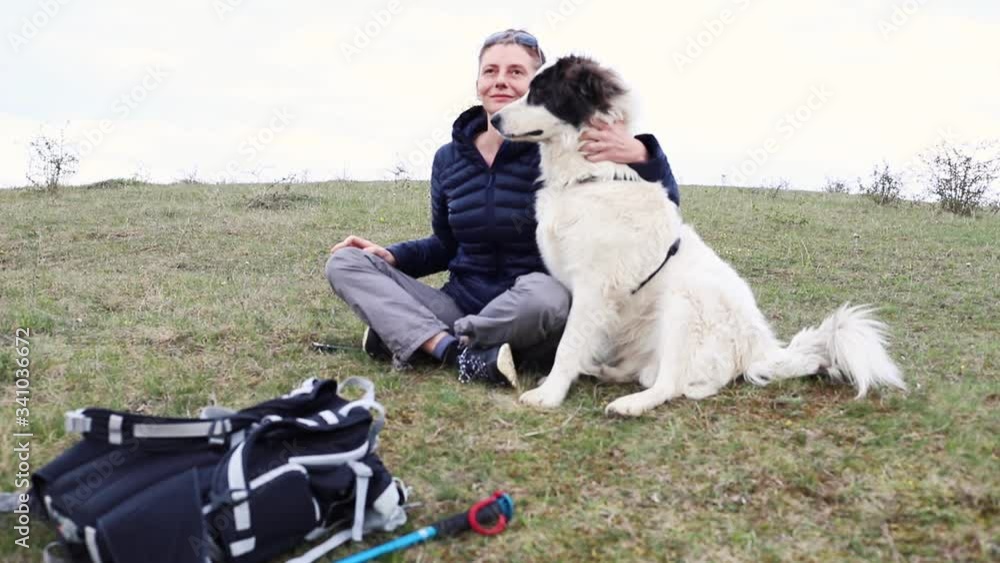 woman petting her white dog outdoors woman petting her white dog outdoors