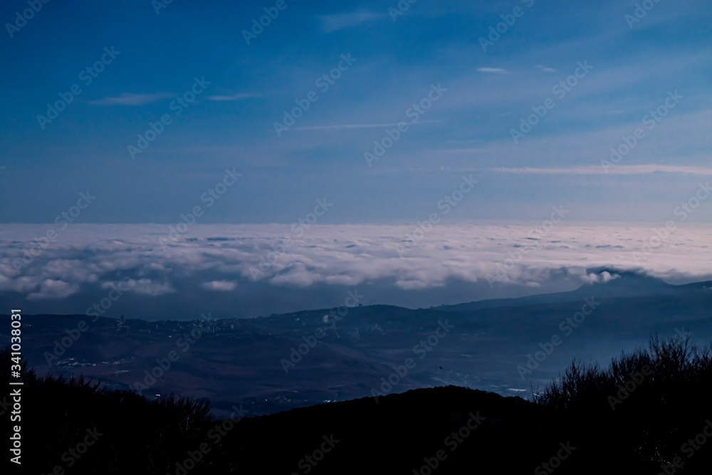 Obraz premium Mountain landscape. Beautiful view above cloudscape