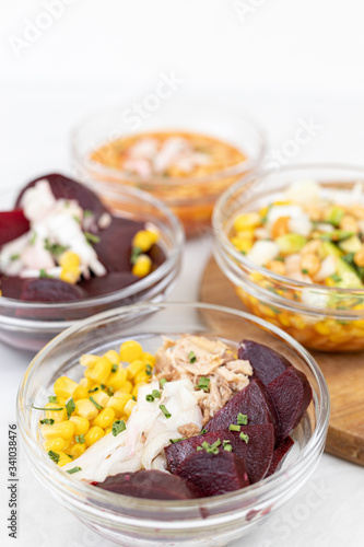 Mixed salads with avocado corn beans beet and onions in bowls