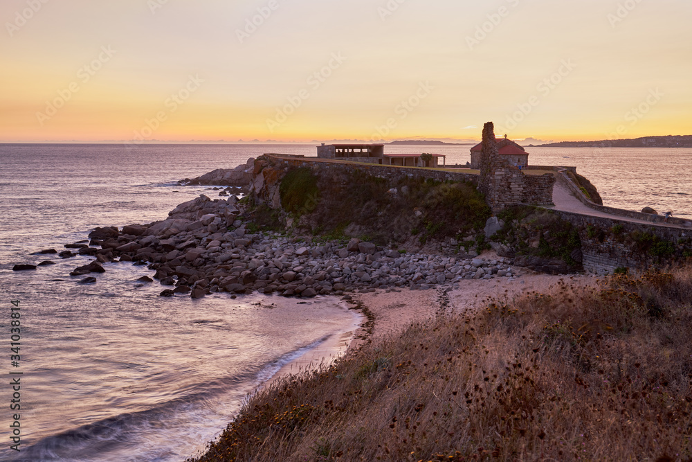 Sunset in the old hermitage of La Lanzada in Galicia, Spain.