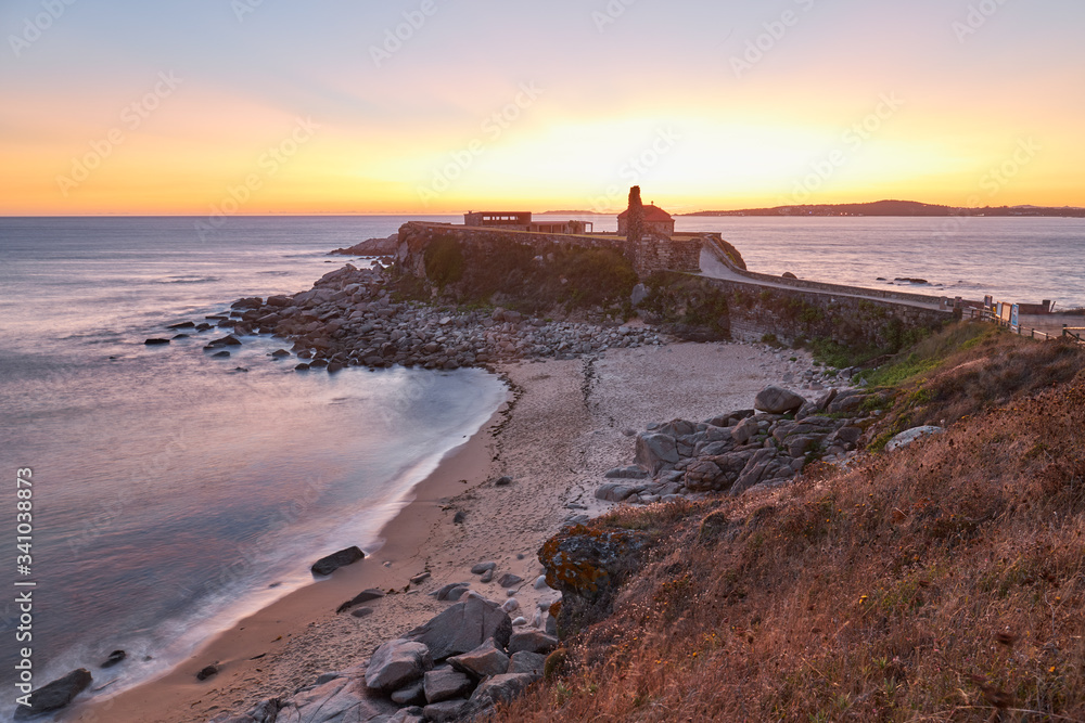 Sunset in the old hermitage of La Lanzada in Galicia, Spain.