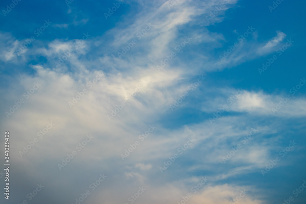 Abstract blurred background Blue sky with white clouds in sunlight.