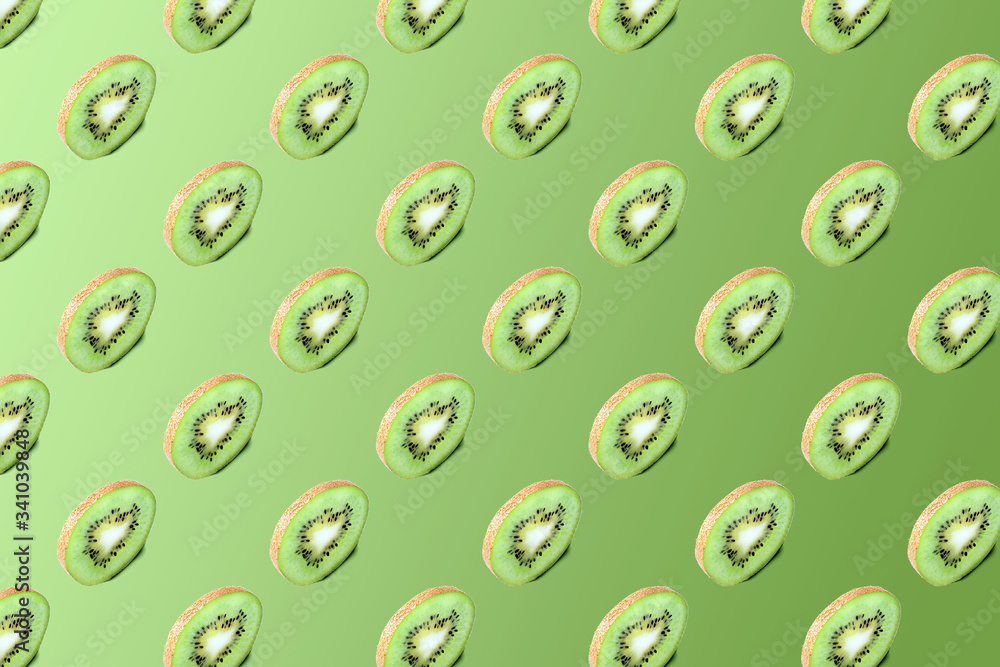 Kiwi slices pattern on a green background. Food texture. Kiwi seamless texture. Kiwi slices pattern on a green background. Food texture. Kiwi seamless texture.
